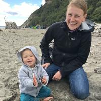 Photo of Karin and child smiling at the beach