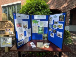 A blue tri-fold display on a table with images and text.