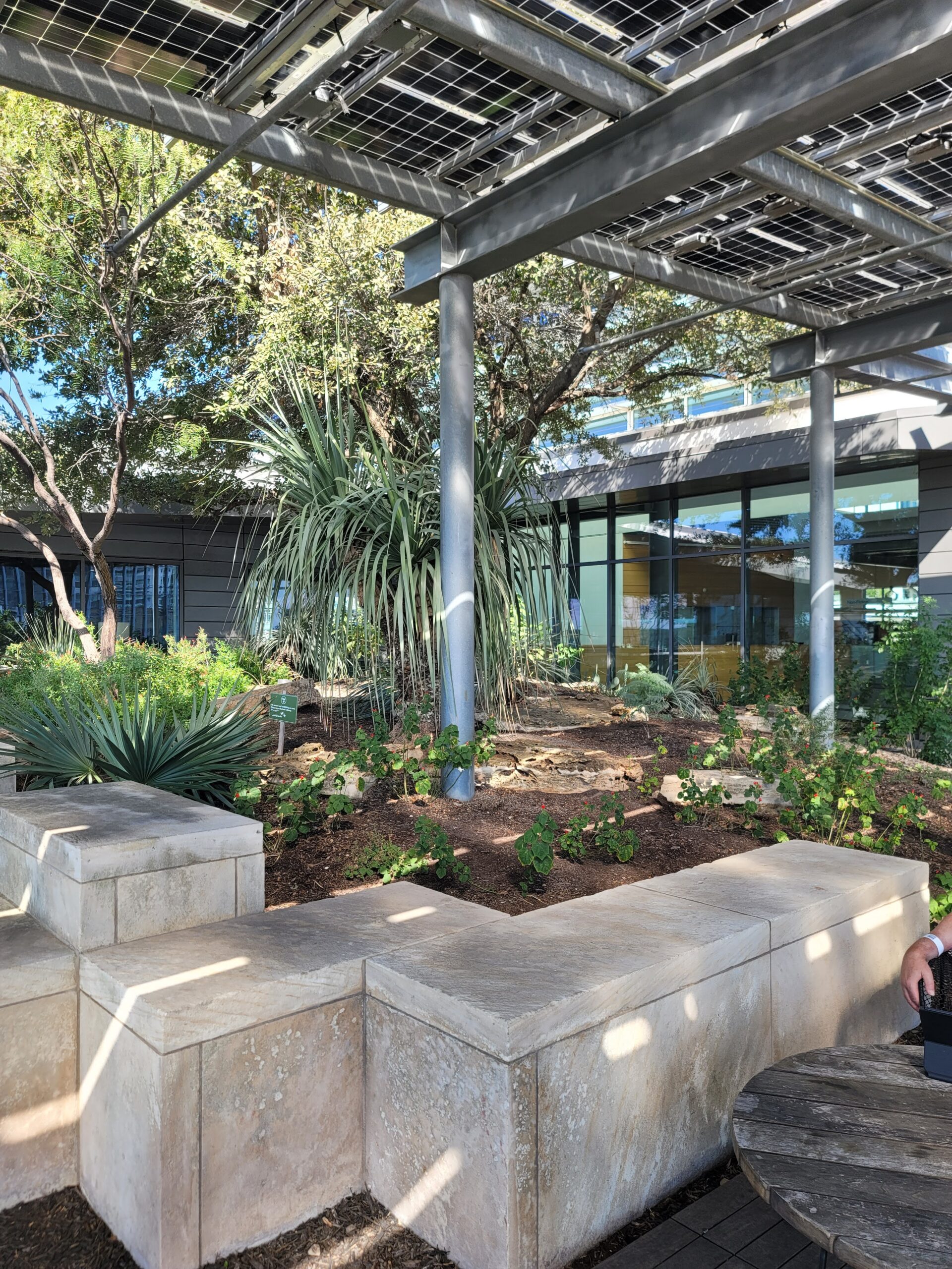 A Semi-covered outdoor area with cement blocks and plants.