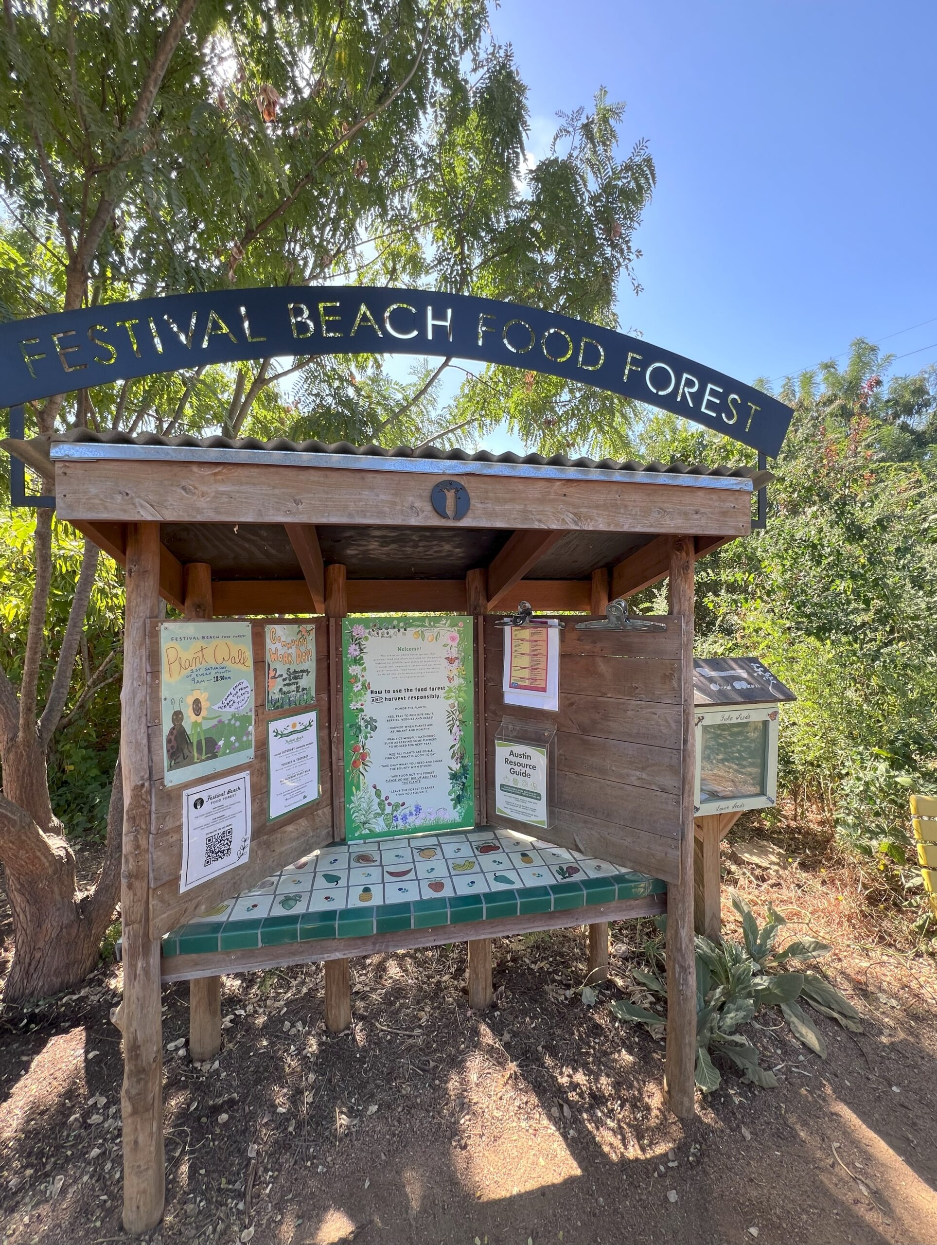 A tiled outdoor wood display kiosk.