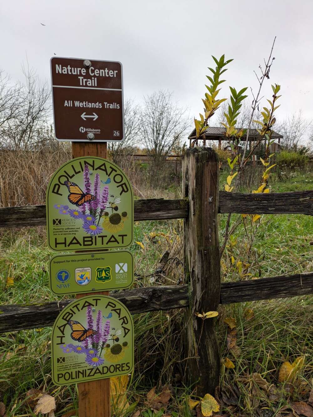 Signs posted on a fence.