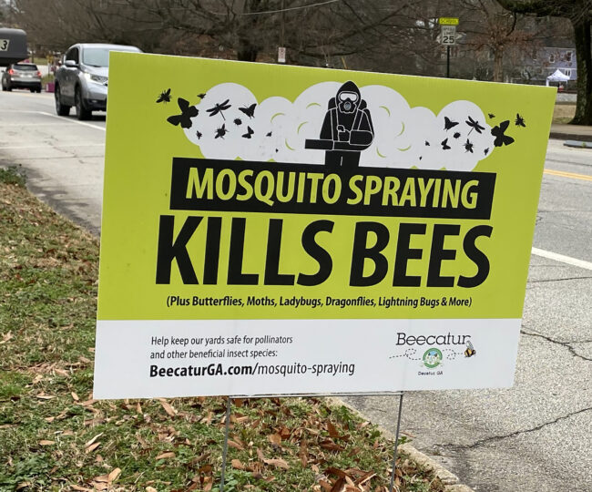 A black, white, and green sign.
